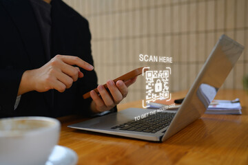 Businessman scanning QR code with smart phone for payment and ID verification. Cybersecurity concept