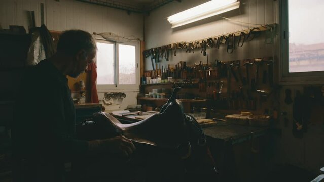 Saddle worker checks and adjusts saddle