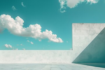 Azure sky with fluffy cumulus clouds behind a concrete wall