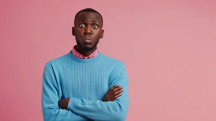 puzzled african american man in blue sweater in amazement on pink isolated background, confused and stunned man hyper realistic 