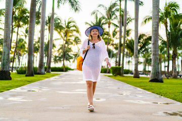 Beautiful woman walking in beach resort
