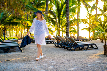 Beautiful woman walking in beach resort

