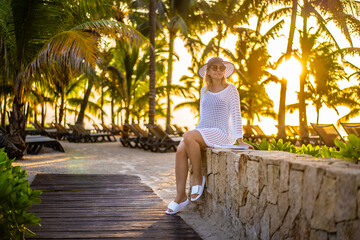 Beautiful woman sitting in beach resort 