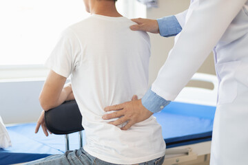 man was admitted for treatment of muscle pain in back of his shoulder due to working hard and causing muscle inflammation. doctor is treating man muscle pain in his back and shoulders due to overwork.
