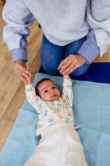 Adorable baby enjoys physical therapy sessions with a qualified therapist in a specialized children's gym or play area.