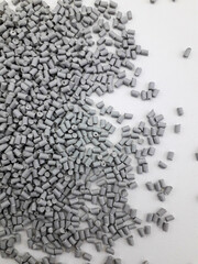 Naklejka premium gray low density polyethylene masterbatch granules on a white background, this polymer is a colorant for products in the plastics industry