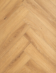  Geringbone pattern laminate in light brown with shades of beige, imitating the texture of natural...