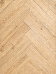 Geringbone pattern laminate in light brown with shades of beige, imitating the texture of natural wood.