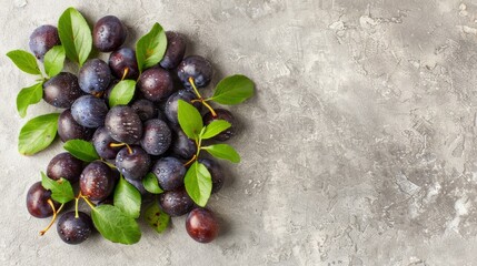   A mound of plums topped with green foliage against a gray backdrop, featuring a gray cement surface - Powered by Adobe