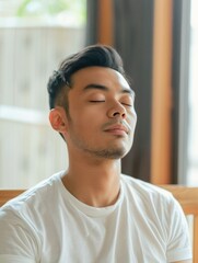 Fototapeta premium Southeast Asian Man Practicing Mindful Breathing for Mental Health in a Serene Room