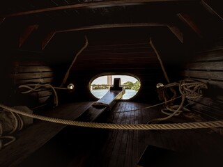 Interior of the stern area with the rudder for steering in the wooden replica carrack historical...