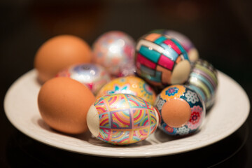 Closeup of chicken eggs on Easter against a dark background. Decorated eggs, film with a pattern...