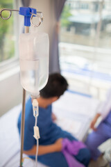 An iron stand to hang saline bottle high to deliver saline via catheter to an intravenous patient...