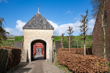 Entrance over bridge in rampart of the village of Bourtange (former Fort Bourtange), near Westerwolde the Netherlands; the fortress was built in 1593 shape of a star  - obrazy, fototapety, plakaty