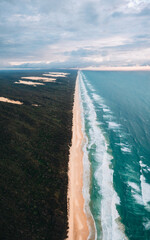 High angle aerial drone view of famous Seventy Five Mile Beach, 75 mile beach on Fraser Island, Kgari, Queensland, Australia, shortly before sunset