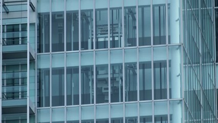 Glass elevators outside the skyscraper building, business architecture. Tilt shot.