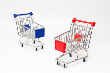 Toy shopping carts in selective focus, on white background.