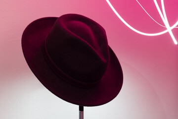 Unisex wide brim fedora hats under pink neon light.