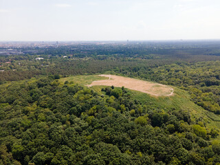 Naklejka premium Aerial landscape of Drachenberg trash mountain in Grunewald forest on a sunny day in Berlin