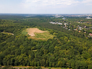Aerial landscape of Drachenberg trash mountain in Grunewald forest on a sunny day in Berlin