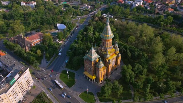 Aerial view of the beautiful city of Timisoara, Romania. Footage was shot from a drone at a higher altitude with camera lowered for a birds eye view of the Mitropolitan Cathedral.