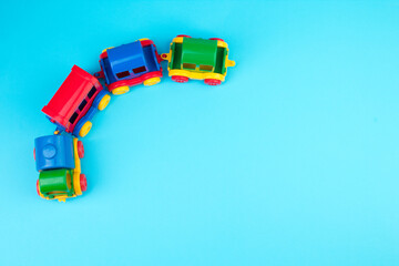 Children's toy, a multi-colored steam locomotive on a blue background. For the development of the child.