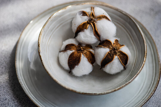 Close-up of a place setting on a table with balls of cotton
