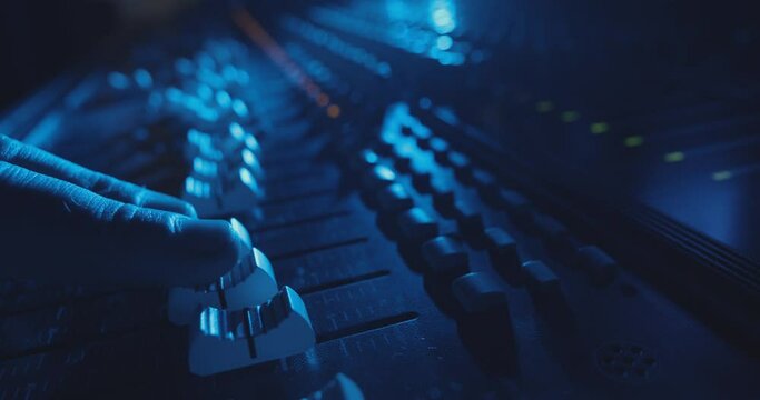 DJ Adjusting Audio Levels on Professional Console in Cinematic Atmosphere