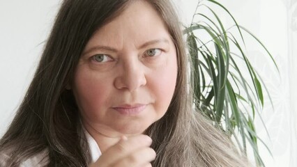 closeup face mature woman 55 years old, human fat neck, side view, double saggy chin, deep wrinkles, age-related skin changes, cosmetic anti-aging procedures, skin tightening