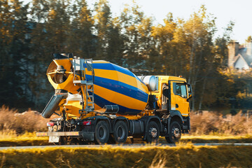Construction machinery. A Cement mixer truck is delivering liquid concrete to the construction site