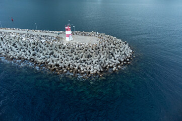 Lighthouse on a rock breakwater © iLopezBa
