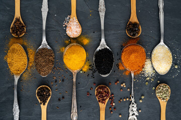 Various spices on tablespoons and small spice spoons