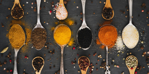 Various spices on tablespoons and small spice spoons