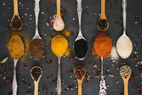 Various spices on tablespoons and small spice spoons