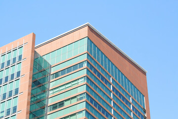 Modern office building photograph. Windows on the side of a large urban building. 