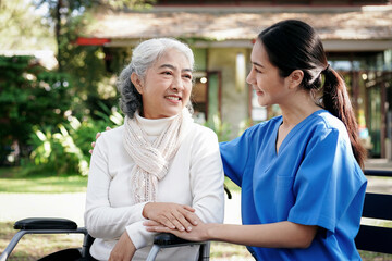 A woman in a white shirt is sitting on a bench with a woman in a blue uniform