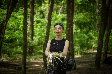 Girl Walking Through Forest Holding Dandelions