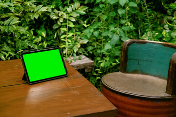 Green Screen iPad or Tablet on Wooden Table with Green Plants Background