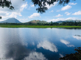 Lake serenity: stunning green mountains backdrop
