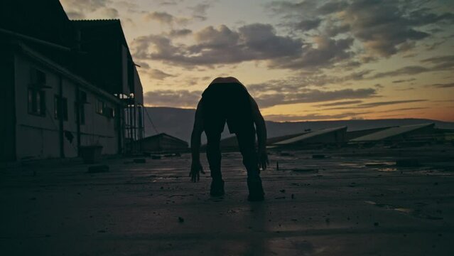 Man runs outside at sunset