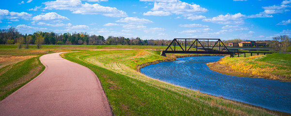 Tranquil Big Sioux River Walking Trail curved through Sertoma Park in Sioux Falls , South Dakota,on...