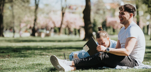 Teenage students engaged in homework at a park, helping each other with studies, surrounded by...