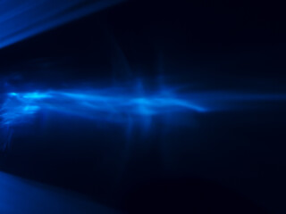Blue light reflected in the dark for an energy minimalist abstract background.