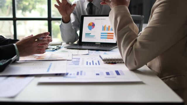Financial advisor meeting is discussing analysis of business growth chart and market situation and financial planning.