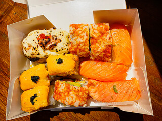 Various salmon sushi at paper wrap
