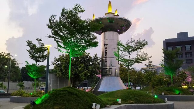 monument landmark in Ahmedabad city in Gujarat showing the core values of the city lit up with coloured lights at night with trees all around