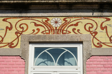 detail of an art nouveau azulejos frieze on a house in Braga, Portugal