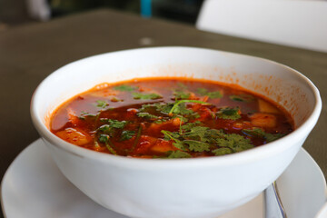Red curry in a white bowl
