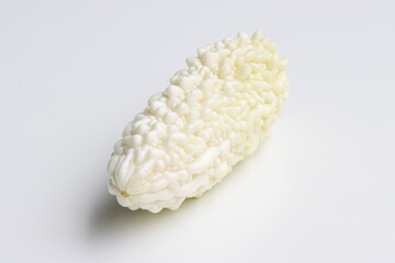 A fresh white bitter melon isolated on a white background. Bitter melon (Momordica charantia) is a tropical and subtropical vine of the family Cucurbitaceae grown for its edible fruit.