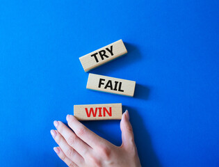 Try Fail Win symbol. Concept words Try Fail Win on wooden blocks. Beautiful blue background....